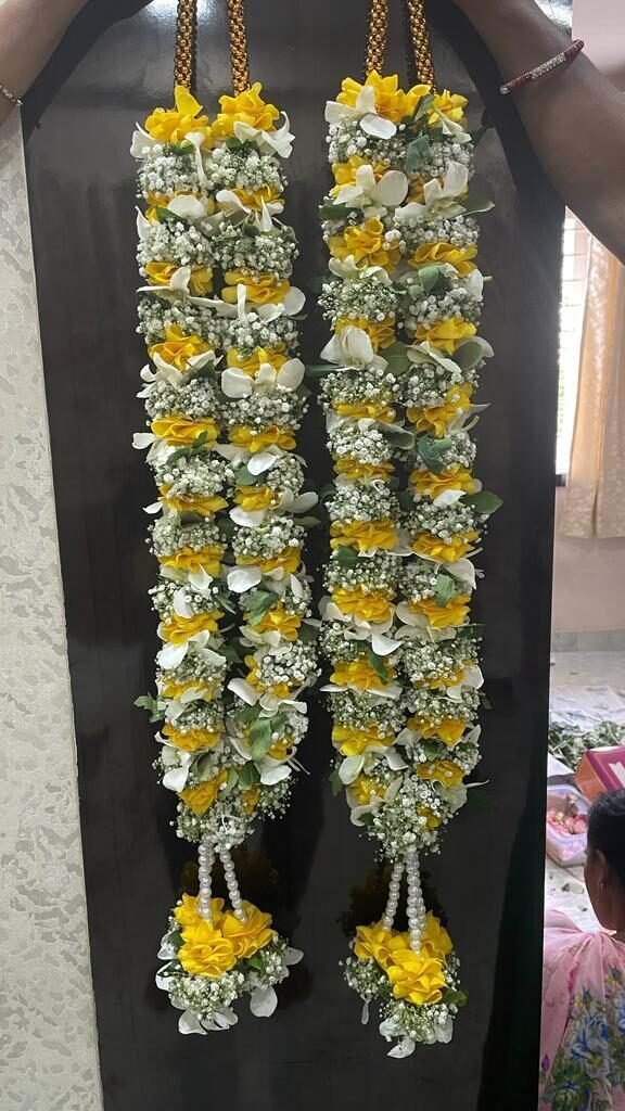 White orchid , yellow rose petals, gypsy flowers with little green.  Light weight and different model Wedding Garland
